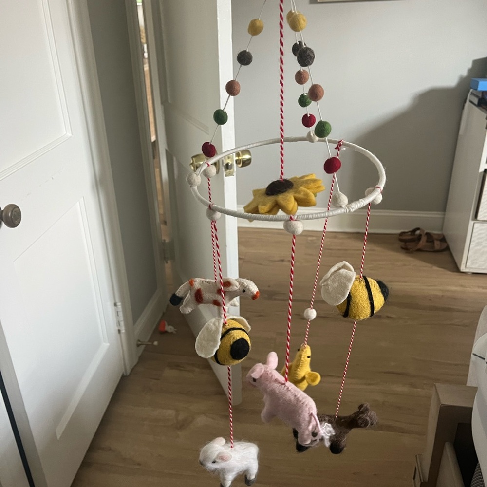 Whimsical Animal Mobile with Yellow and Pink Accents